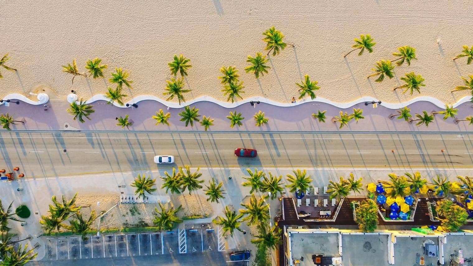 aerial view of road running alongside the beach